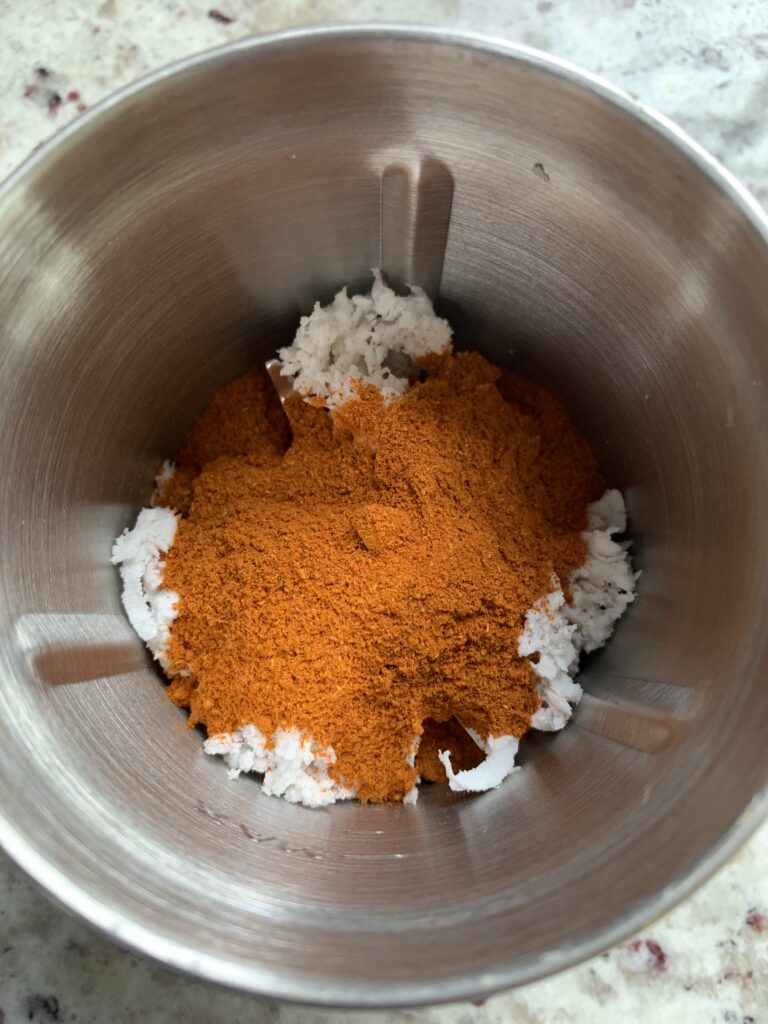 add coconut and Sambar powder to a grinder